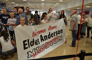 Starting to gather at the airport with our welcome home sign