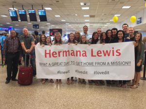 The sign we made for her at the airport and the friends gathered to greet her.